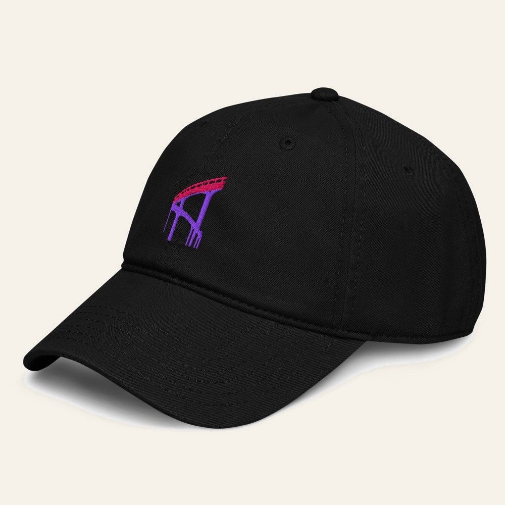 The De la Ciudad Cap in Black, angle. Viaduct in flamingo pink and purple thread.